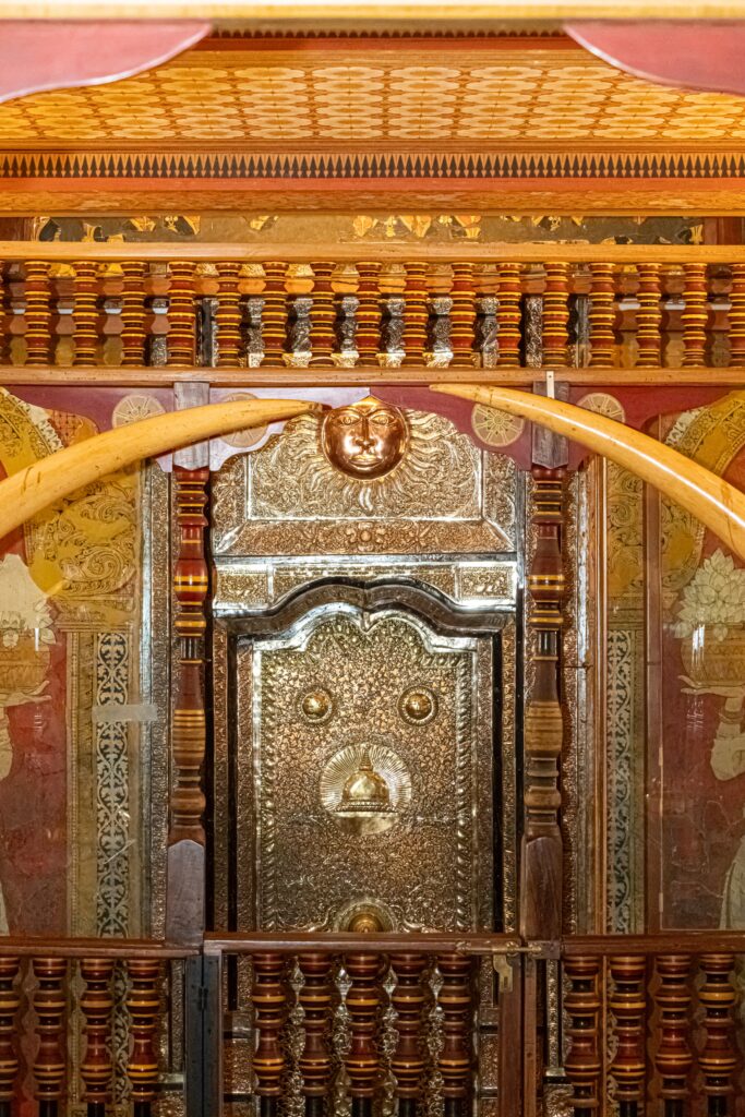 Intricate architecture and golden doors inside the Sacred Temple of the Tooth Relic in Kandy.