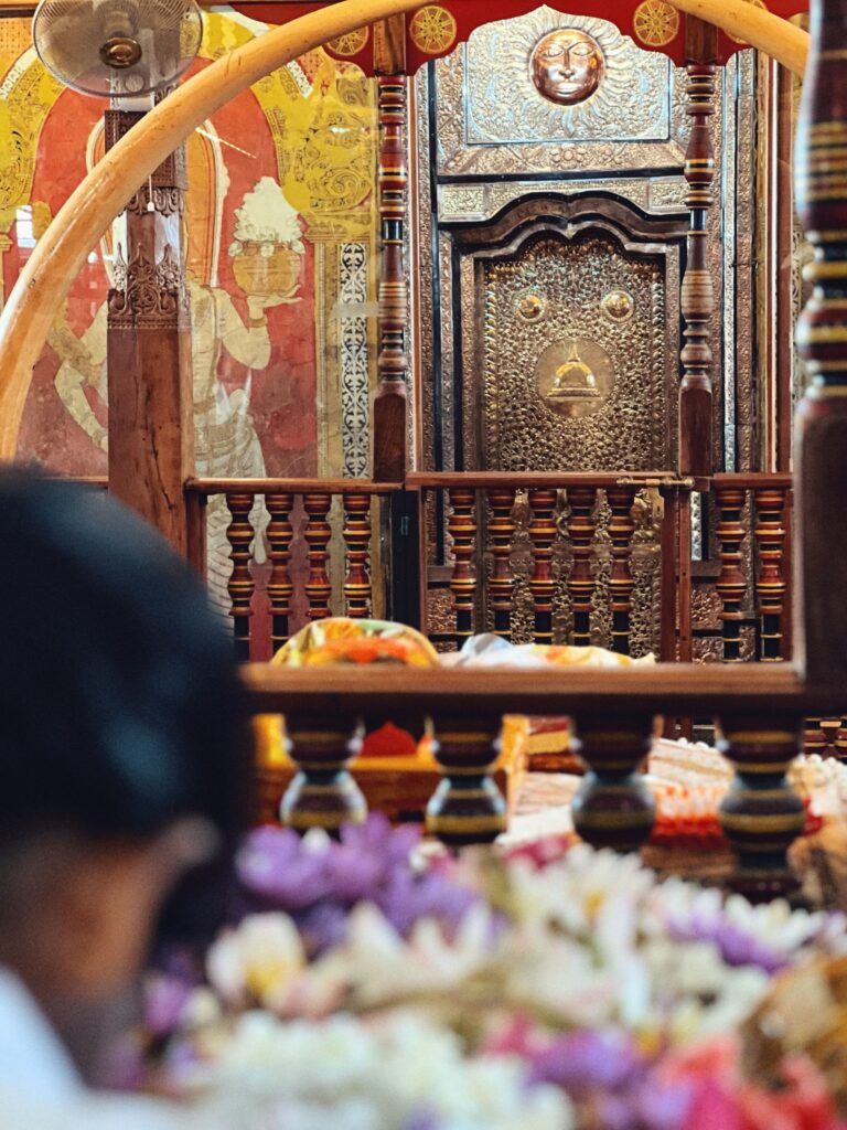 Close-up view of the ornate golden doorway and sacred shrines inside the Temple of the Tooth.